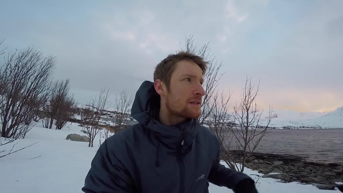 caption: Heaton walking fjord edge searching for foreground elements