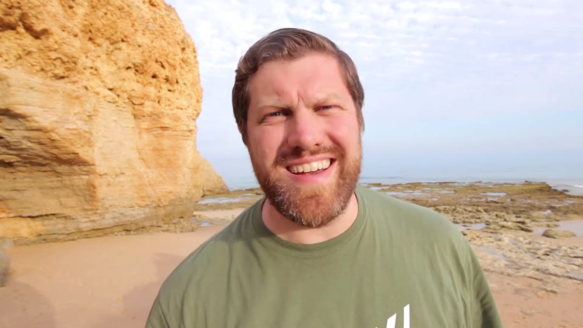Photographer walking coastline looking for compositions