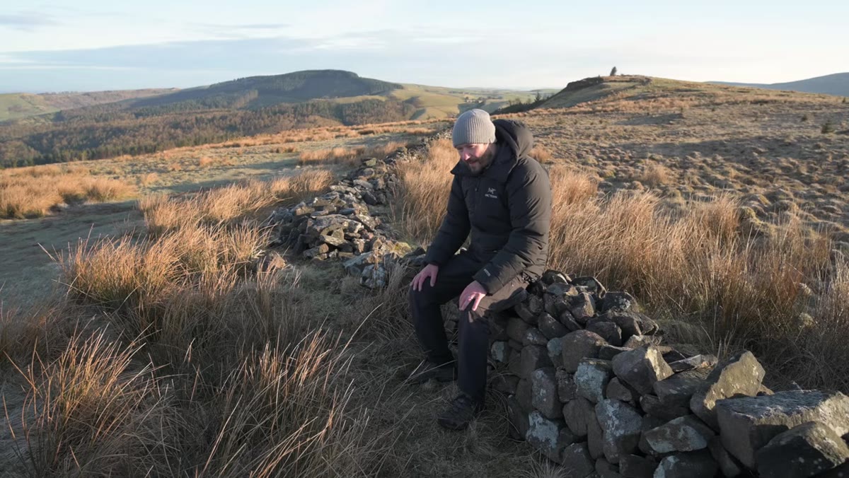 Nigel walking through flat, open landscape at dawn