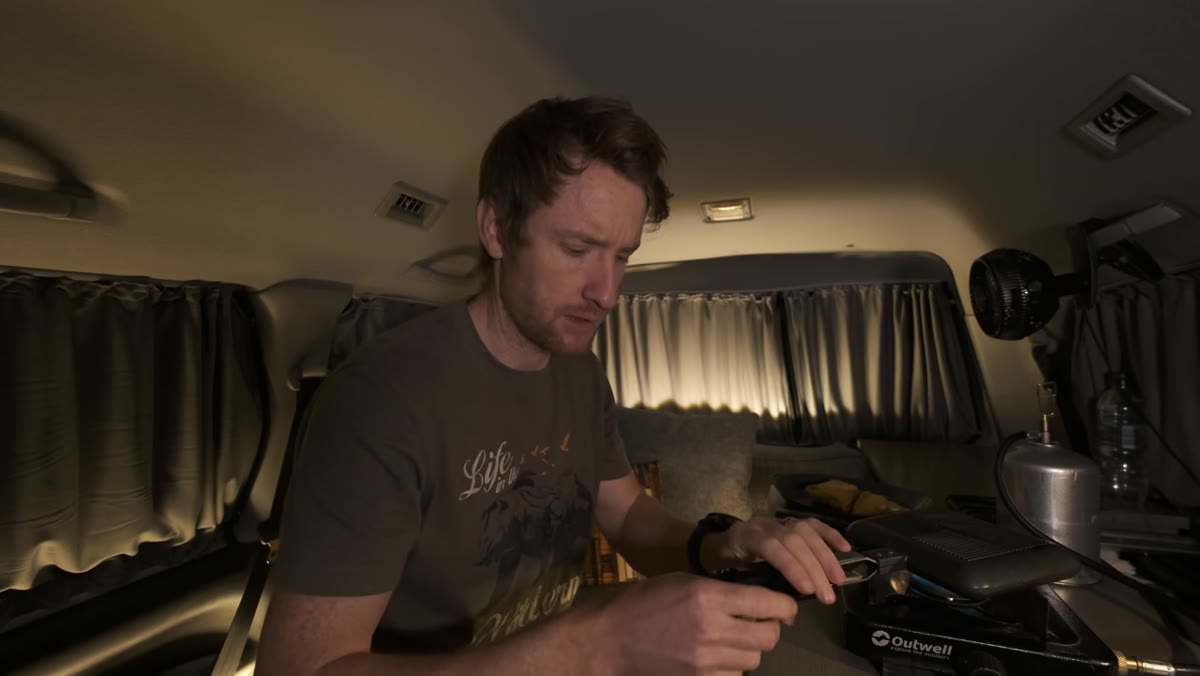 Thomas sitting in van eating, talking about pre-shoot uncertainty