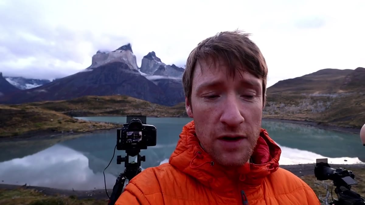 Thomas filming the still lake with mountains reflecting perfectly