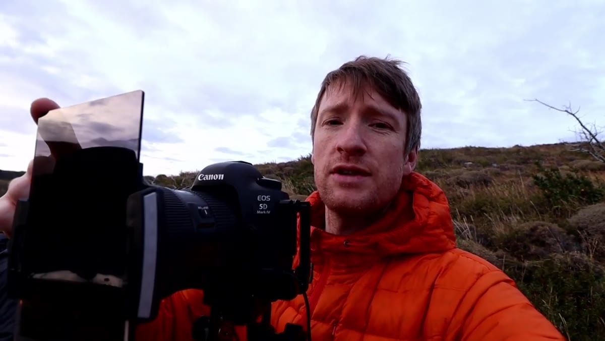 Camera with grad ND filter mounted, shooting toward the mountains