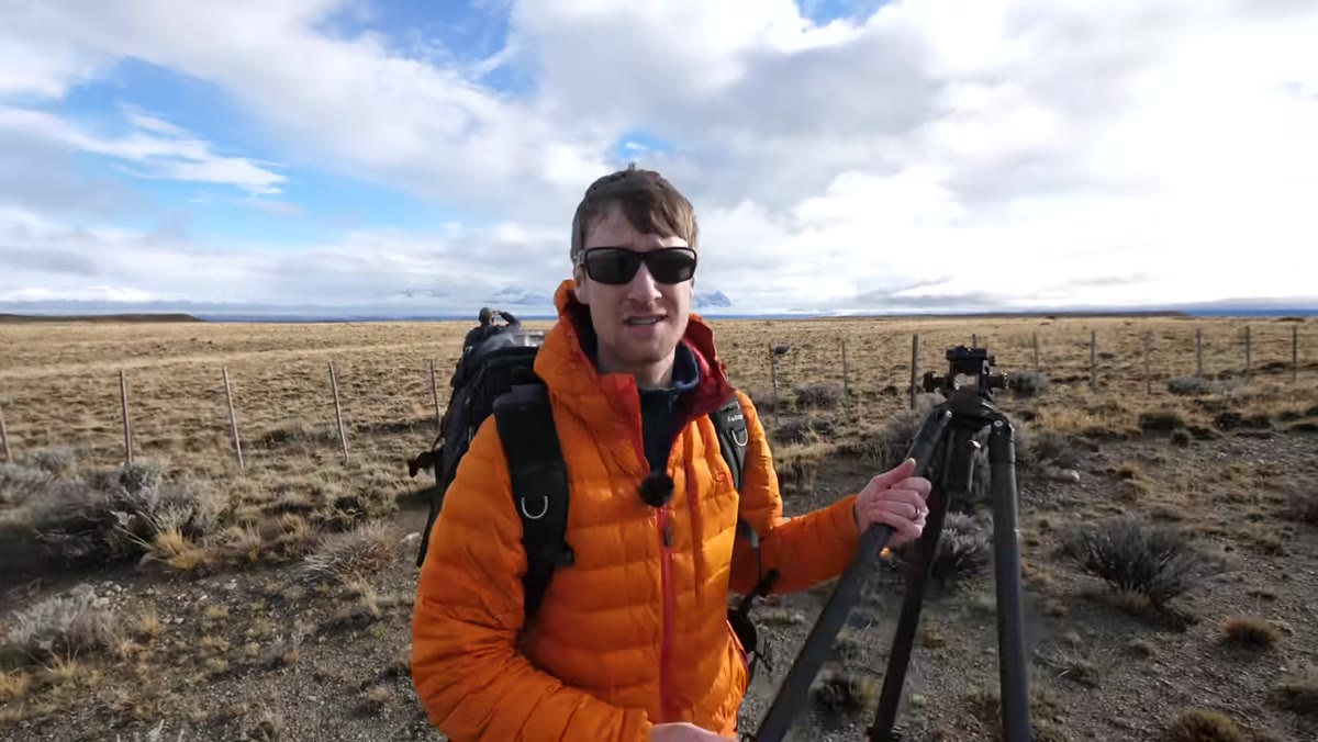 Heaton scanning the sky, noting rapid cloud movement over mountains
