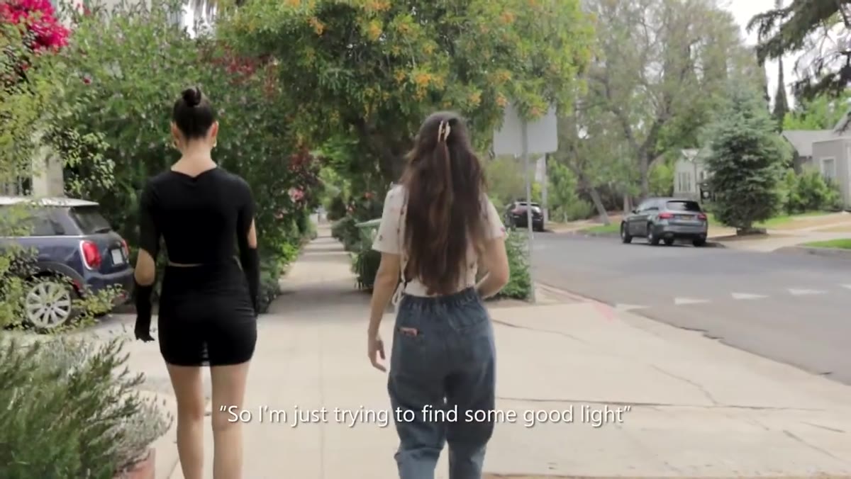Photographer moves through outdoor space searching for light quality