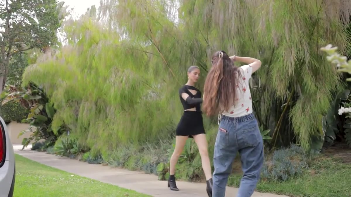 Subject walks toward camera while photographer shoots and adjusts timing