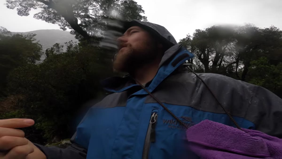 Michael setting up camera composition near river in rain