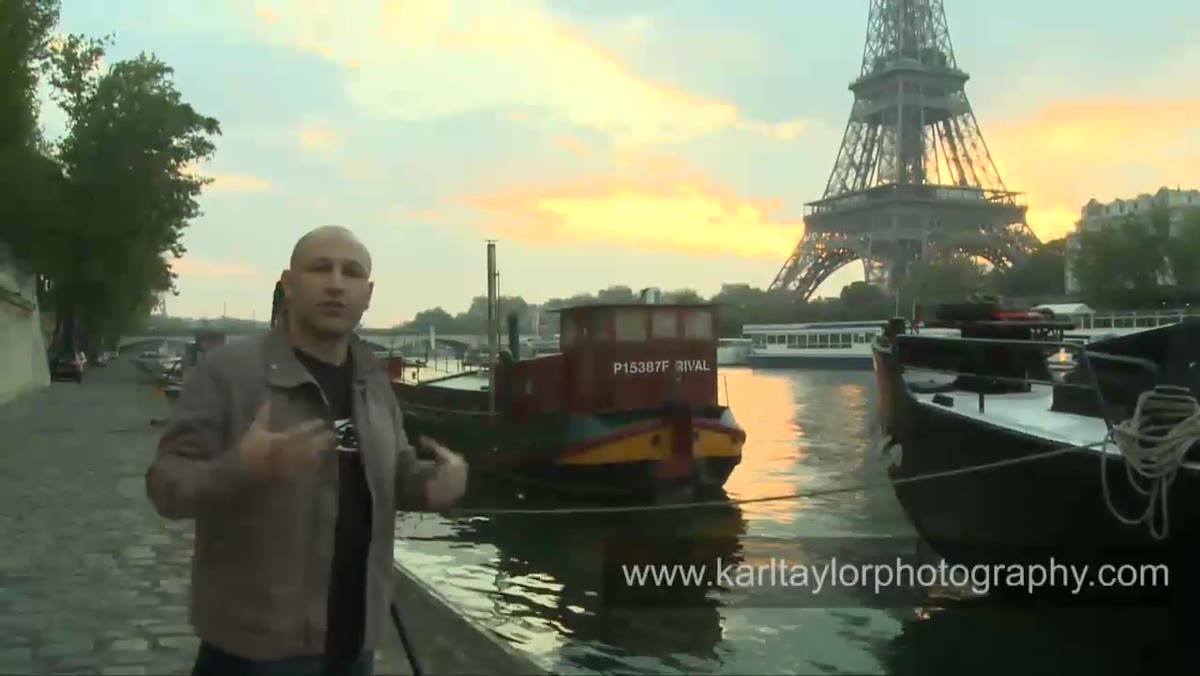 Karl framing a shot between two barges toward the Eiffel Tower at sunrise
