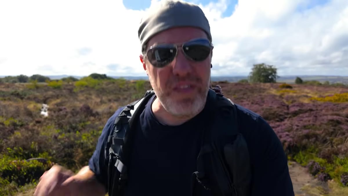 Wide shot of heather-covered hills, rich purples after recent rain