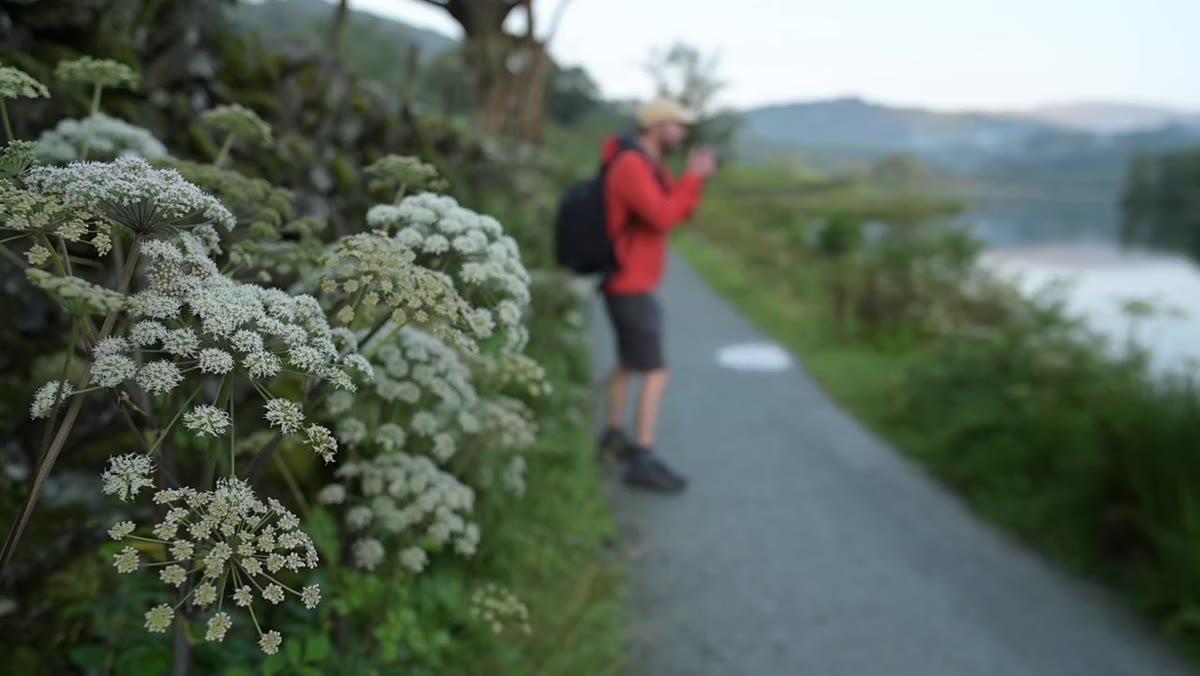 Nigel shooting handheld in low light near a stone hut