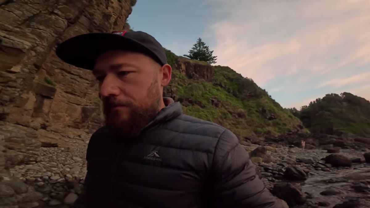 Patino adjusting position to balance foreground rocks, midground water, and background stacks