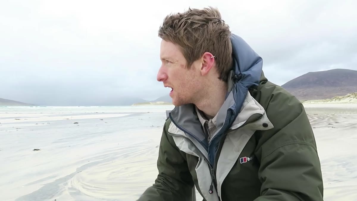 Heaton arriving at a new beach with textured black-and-white sand patterns