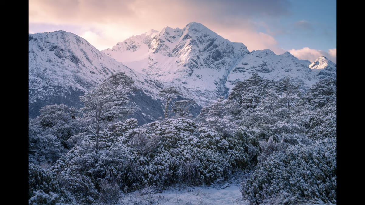 Camera settings displayed: f/16, 1/50s, ISO 100 in snowy mountain scene