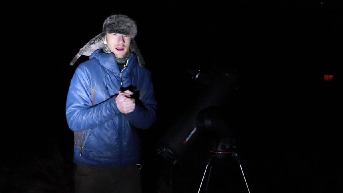 Thomas low to the ground, telescope visible as foreground element