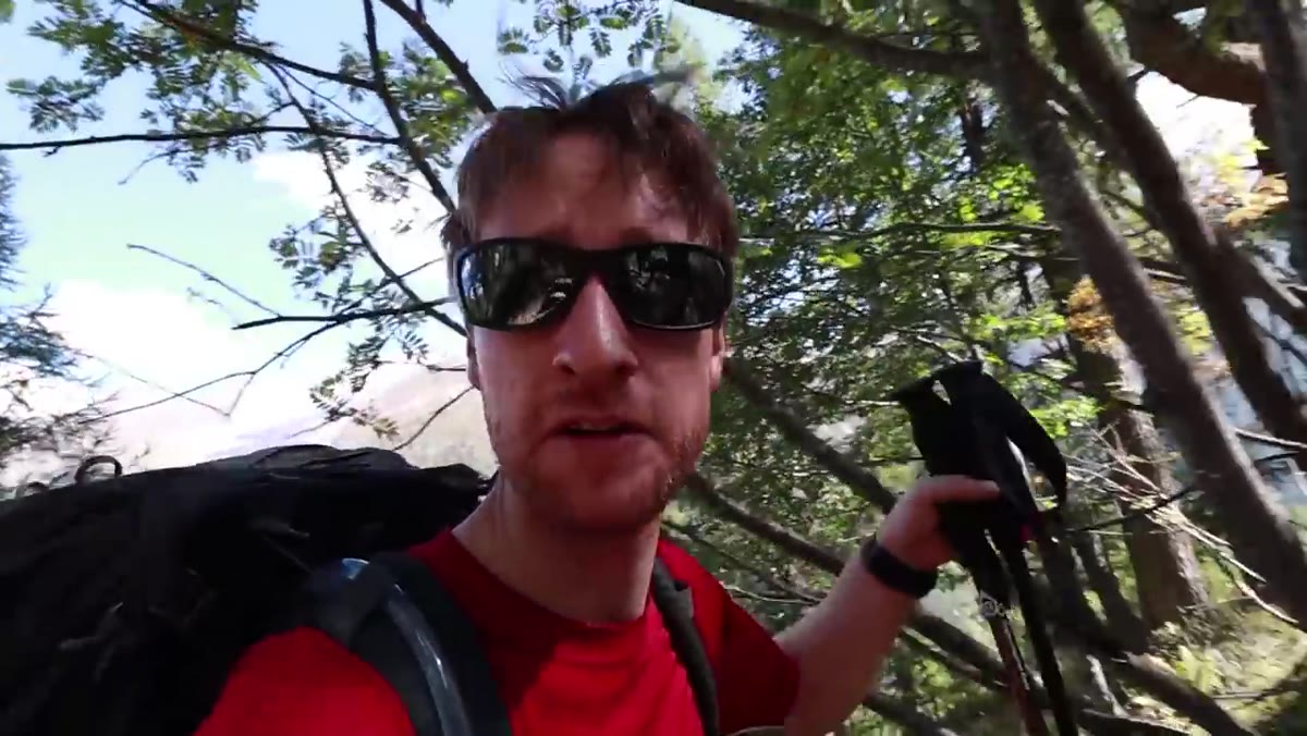 Hikers ascending steep trail above Chamonix Valley in heat