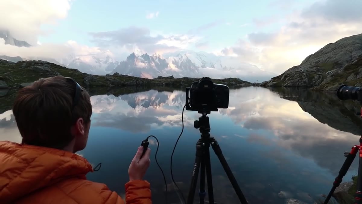 Heaton checking camera settings and reviewing exposure on the lake shore