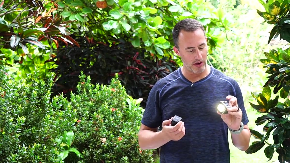 Matt holding the LumeCube and demonstrating the button on top