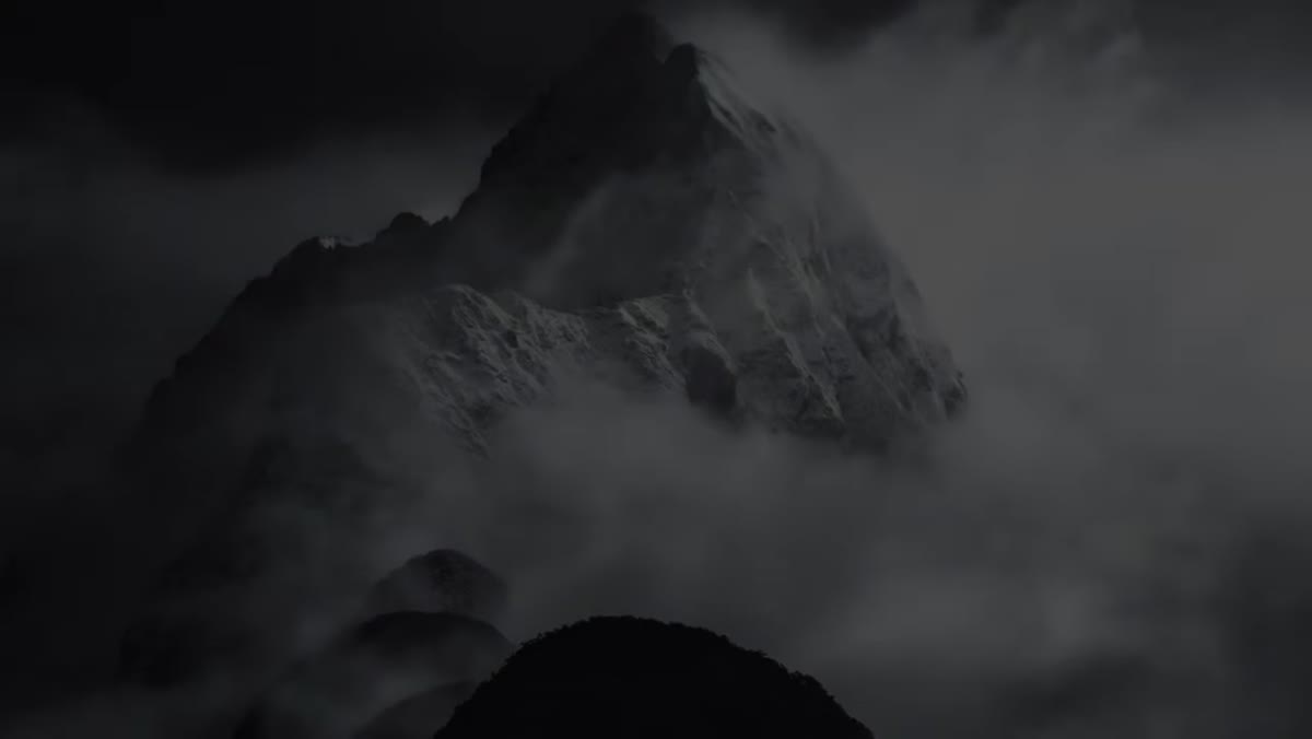 Long telephoto lens isolating layers and atmospheric mountain detail