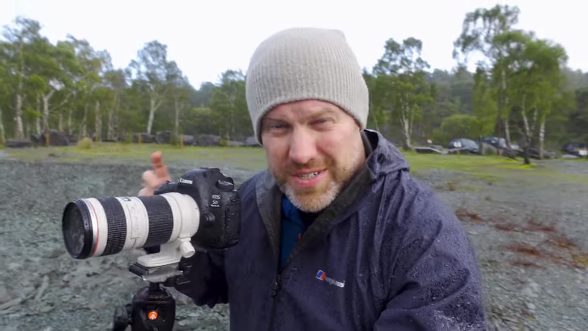 Adam set up on high ground with camera trained on a single tree