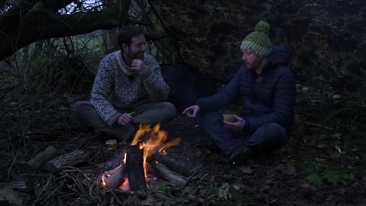 Nigel laughing about not photographing the robin, firelight on his face