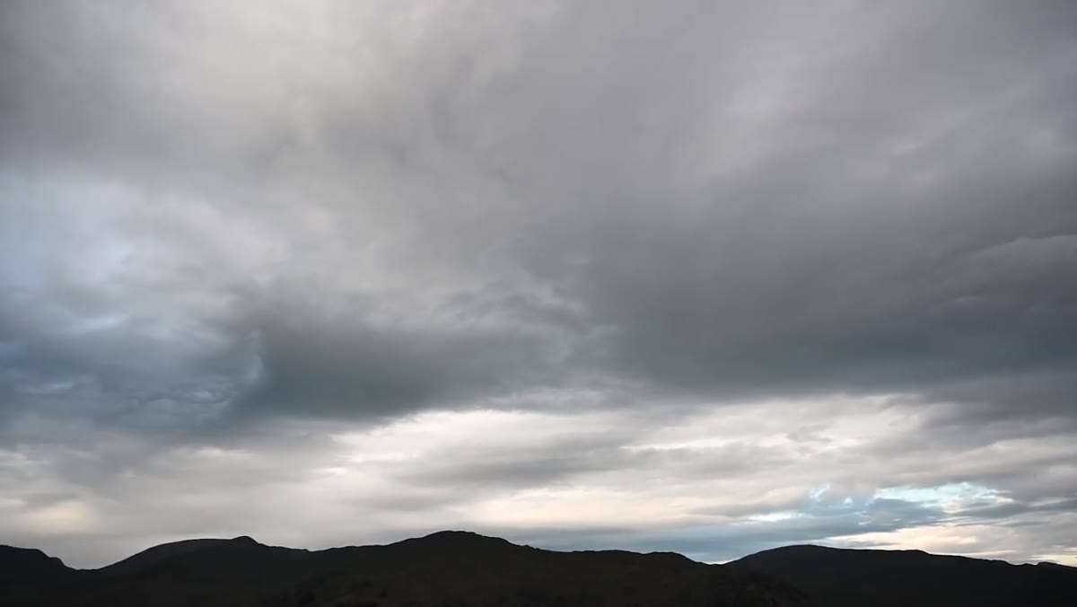 Wide view showing dramatic cloud structure above the fell