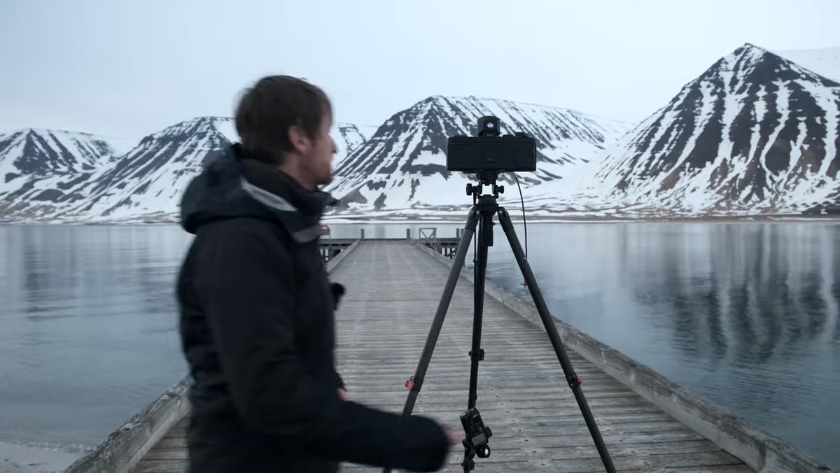 Heaton shooting final frames of black and white film on fjord