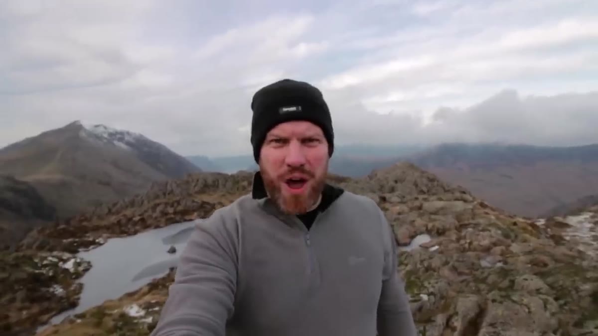 Top of Haystacks, visibly windy with weather rolling in across ridge