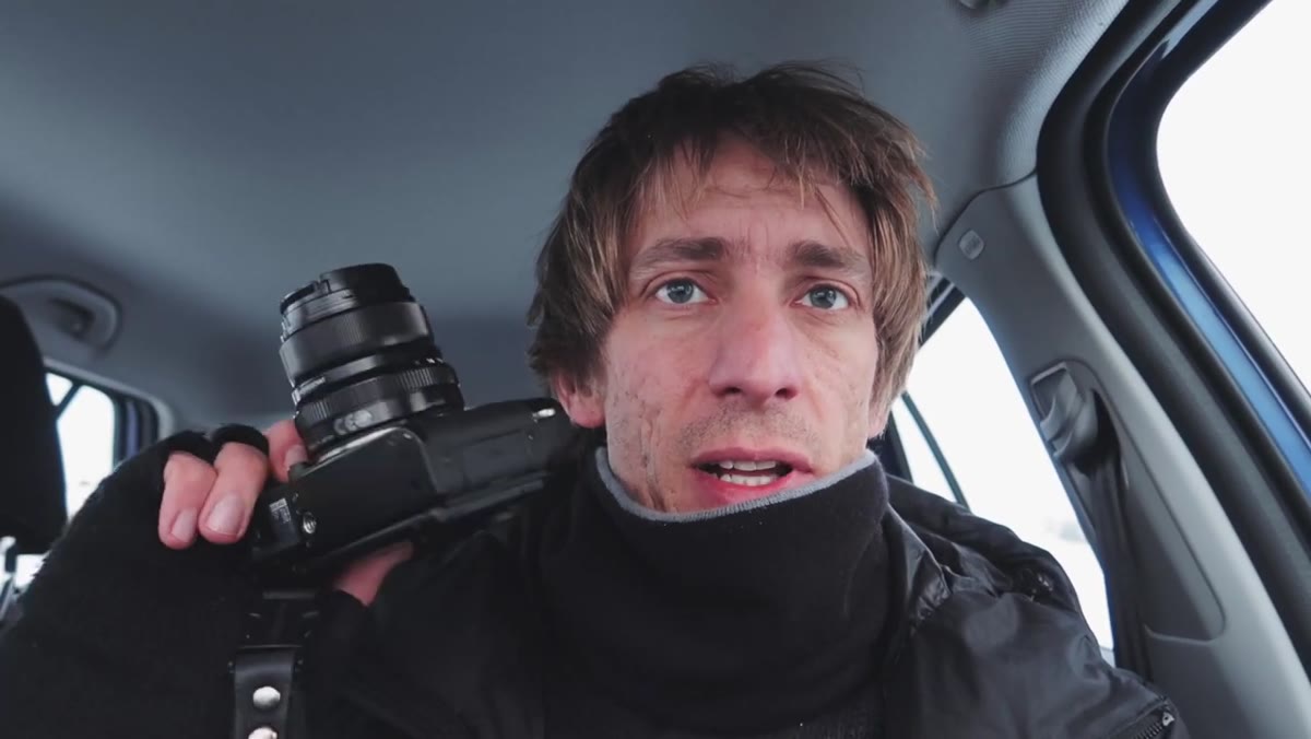 Tucker discussing camera settings in the car after the shoot